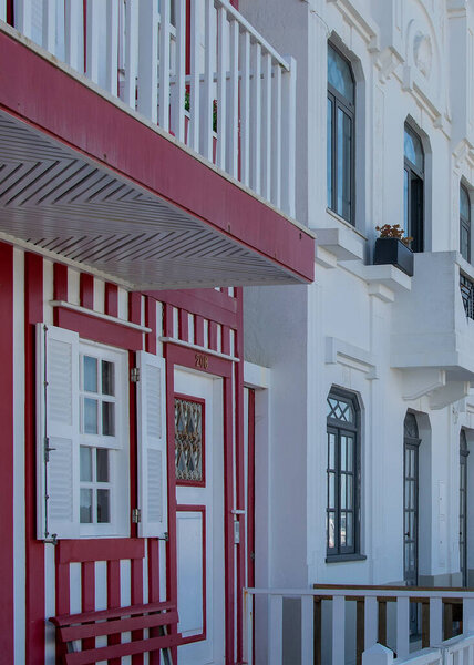 Perspective view of traditional striped houses in Costa Nova, Aveiro,  Portugal, symbol of local identity and colorful architecture