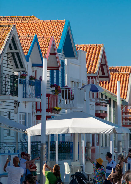 Aveiro, Portugal: August 15 2023: Perspective view of traditional striped houses in Costa Nova, Aveiro,  Portugal, symbol of local identity and colorful architecture