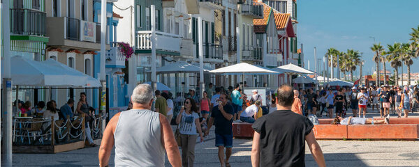 Aveiro, Portugal: August 15 2023: Perspective view of traditional striped houses in Costa Nova, Aveiro,  Portugal, symbol of local identity and colorful architecture