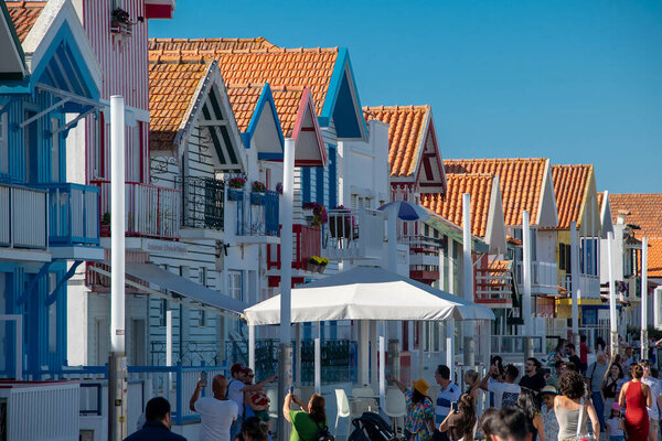 Aveiro, Portugal: August 15 2023: Perspective view of traditional striped houses in Costa Nova, Aveiro,  Portugal, symbol of local identity and colorful architecture