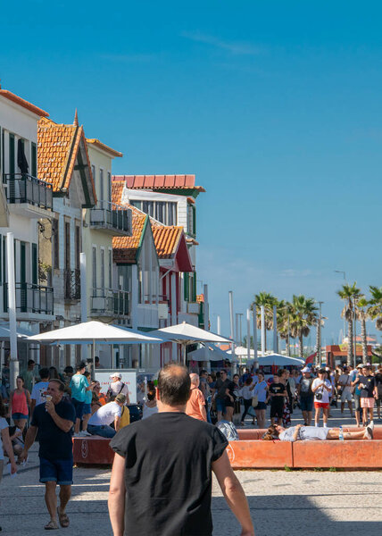 Aveiro, Portugal: August 15 2023: Perspective view of traditional striped houses in Costa Nova, Aveiro,  Portugal, symbol of local identity and colorful architecture
