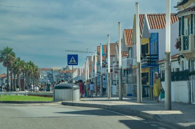 Aveiro, Portugal: August 15 2023: Perspective view of traditional striped houses in Costa Nova, Aveiro,  Portugal, symbol of local identity and colorful architecture