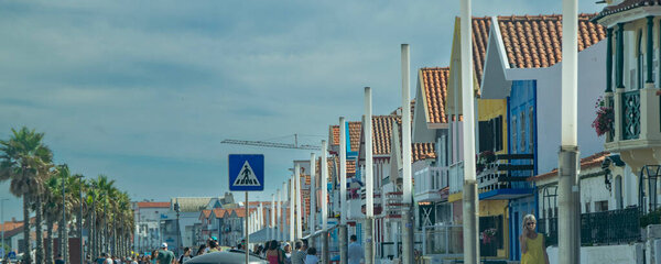 Aveiro, Portugal: August 15 2023: Perspective view of traditional striped houses in Costa Nova, Aveiro,  Portugal, symbol of local identity and colorful architecture