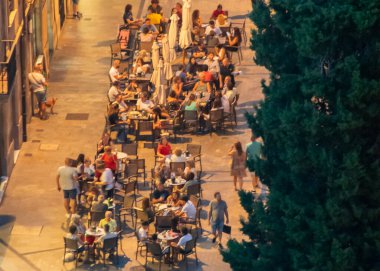 Salamanca, İspanya: 17 Ağustos 2023: İspanya 'nın tarihi merkezi Salamanca' da geleneksel bir yaya caddesinde bir açık hava kentsel kafe manzarası. 