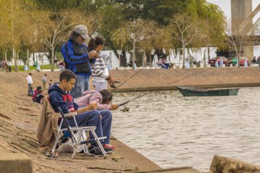 Family Fishing at the Coast of River in Montevideo clipart