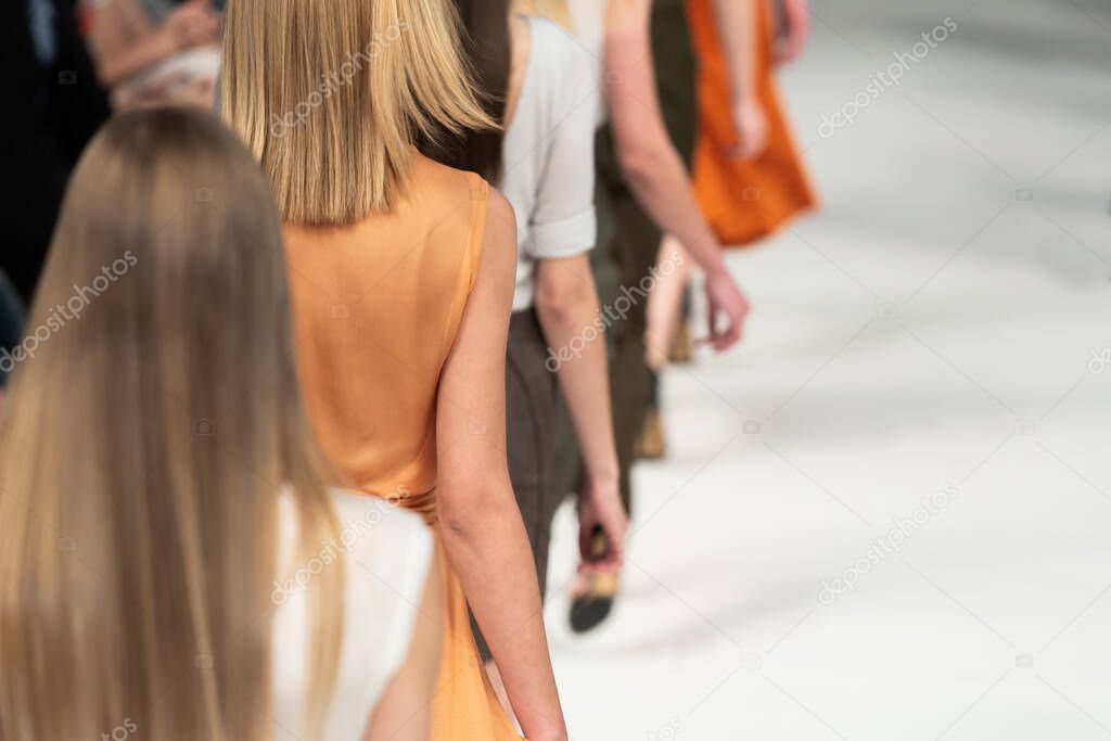 Fashion Show, Catwalk Runway Event, Fashion Week themed photograph. Models walking fashion show finale.