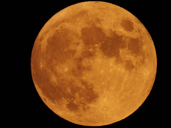 2020 July\'s Hunter moon in the dark night sky over Lakeville, Massachusetts, USA.