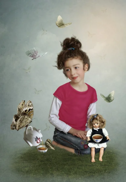 Girl with a doll on Tea party — Stock Photo, Image