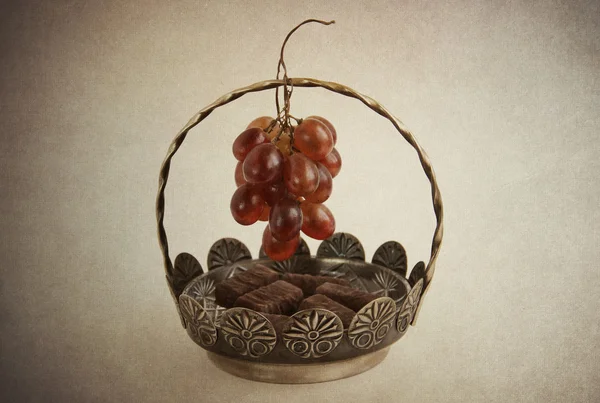 Pralinen in Vase und Trauben — Stockfoto