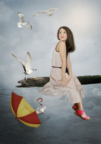 Little girl with seagulls and umbrella