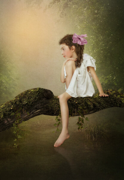 Girl sitting on the tree