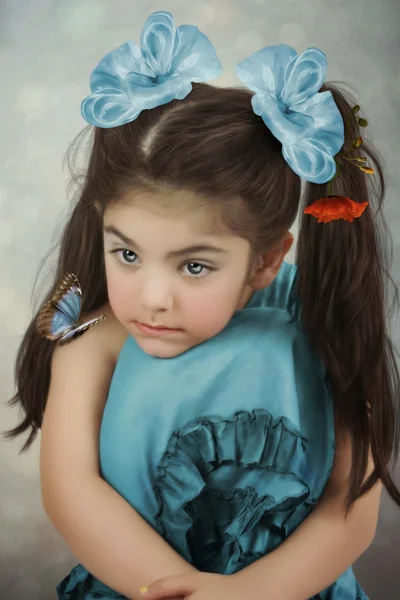 Little girl  with blue bows and  butterfly — Stock Photo, Image