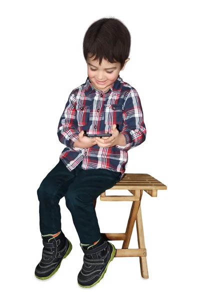 Kid sitting with the phone — Stock Photo, Image