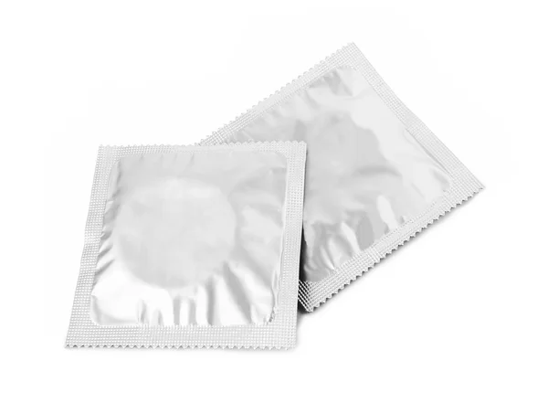 Презервативы на белом — стоковое фото