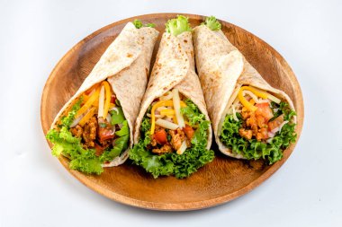 Mexican tacos with chicken meat and vegetables on a white background. 