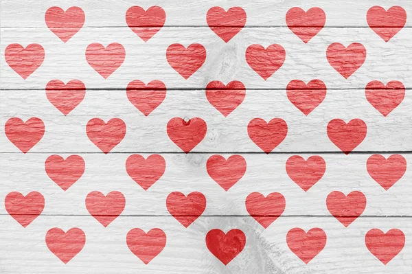 Viele rote Herzsilhouetten auf einer Holzplanke — Stockfoto