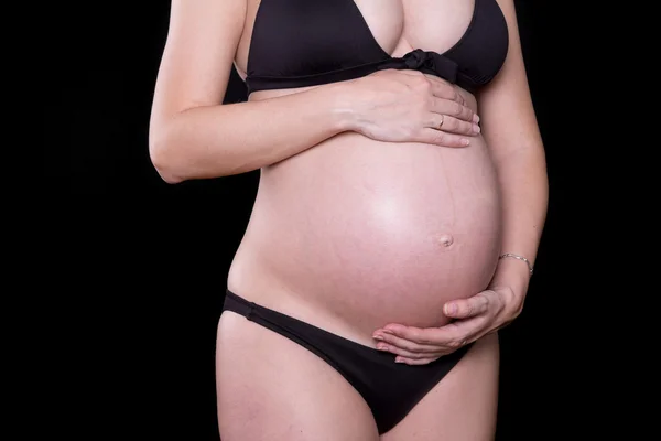 Close up of a cute pregnant belly with black background — Stock Photo, Image