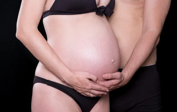 Man hands touching stomach of his pregnant woman — Stock Photo, Image