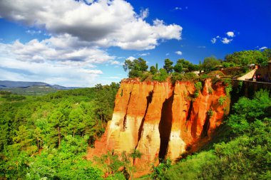 rocks of natural ochre in Roussillon, Provence, France clipart