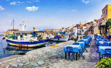 traditional Greece series - Chalki island with old boats and taverna clipart