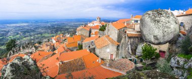 most beautiful villages of Europe - Monsanto  over granite rocks . Portugal clipart