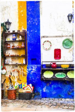 colorful shops of old town Obidos in Portugal clipart