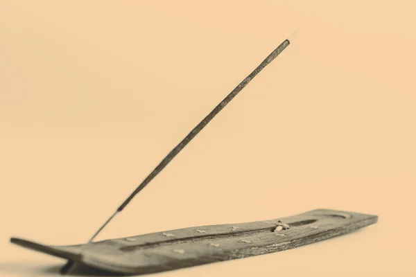 Varilla de incienso sobre un soporte de madera sobre un fondo blanco —  Fotos de Stock