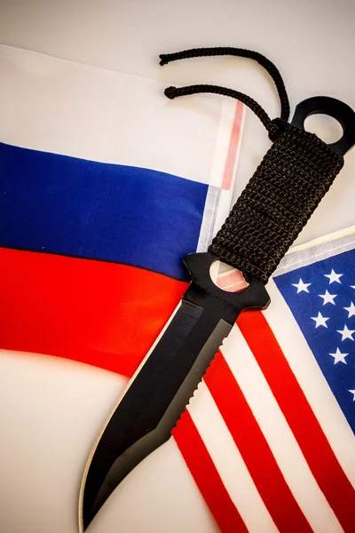 USA and Russia flags with knife - conflict — Stock Photo, Image