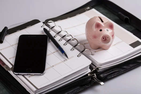 Planning concept - calendar, cellphone, pen, pig moneybox — Stock Photo, Image