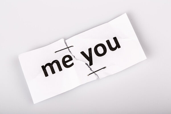 "ME YOU" words written on torn and stapled paper