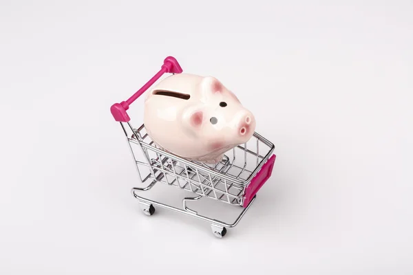 Pig money box in shopping cart on white background — Stock Photo, Image