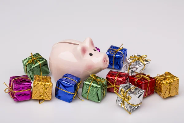 Pig money box between christmas gift — Stock Photo, Image