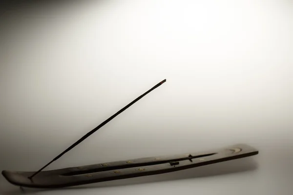 Incense stick on a wooden support on a white background — Stock Photo, Image