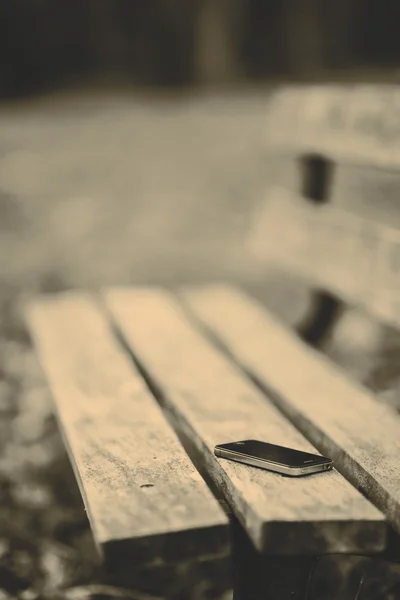 Lost phone on the bench — Stock Photo, Image