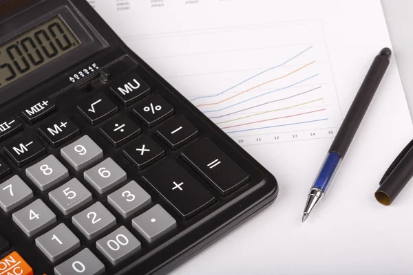 Business Charts with calculator and pen — Stock Photo, Image