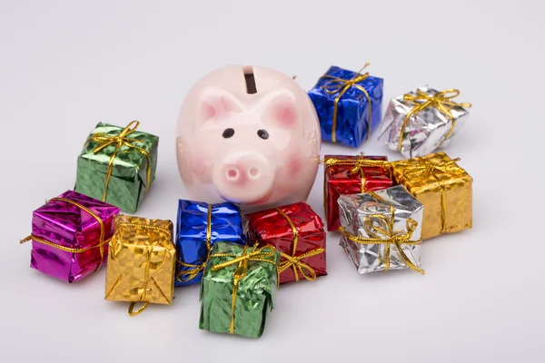 Pig money box between christmas gift — Stock Photo, Image