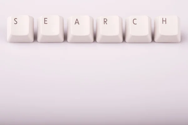 与电脑键盘按键在白色背景上形成的文本搜索 — 图库照片