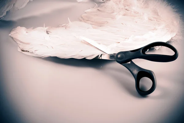 Scissors cutting angel's wing — Stock Photo, Image