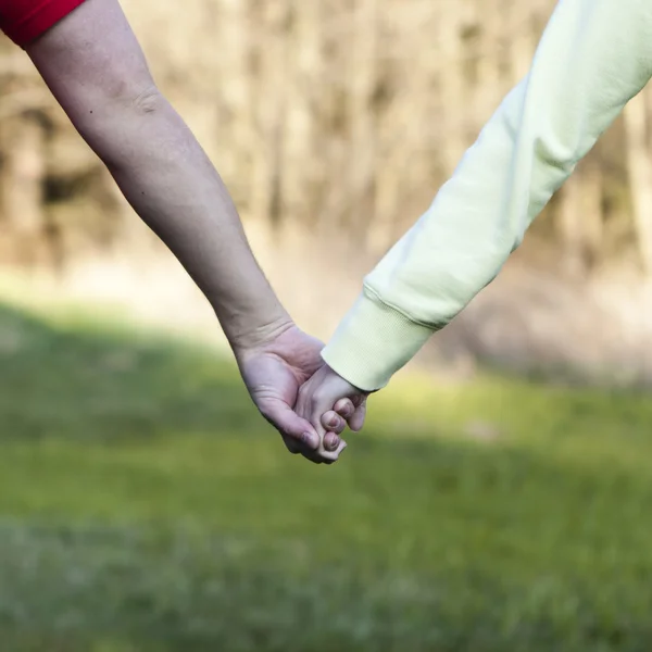 Niño y niña tomados de la mano — Foto de Stock