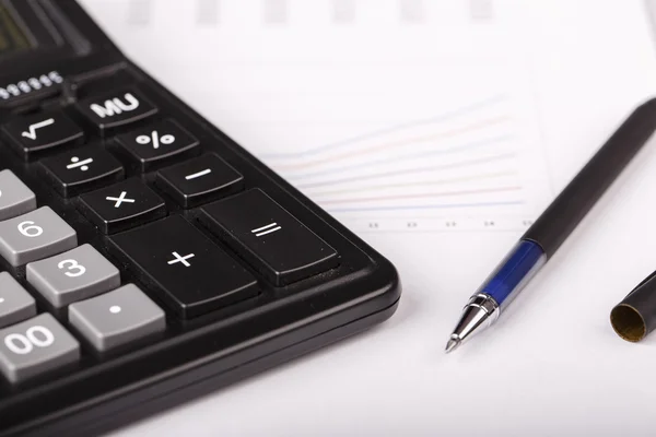 Business Charts with calculator and pen — Stock Photo, Image