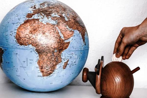 Money box with globe of world — Stock Photo, Image