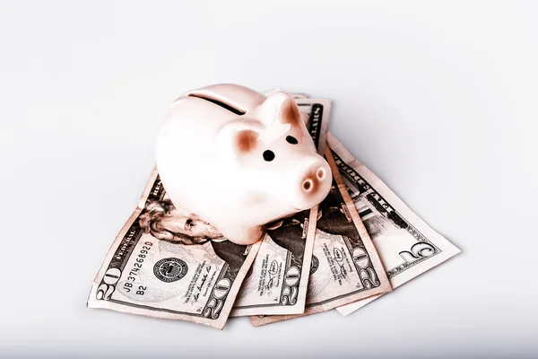 Pig bank on dollar banknotes — Stock Photo, Image