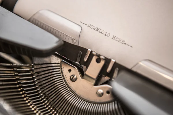 Old typewriter with text download here — Stock Photo, Image