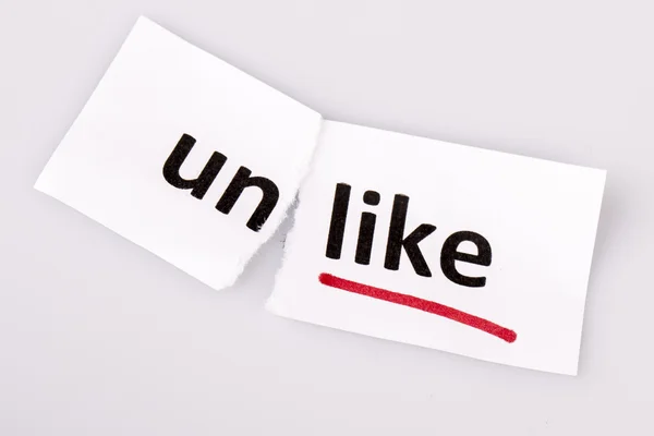 The word unlike changed to like on torn paper — Stock Photo, Image