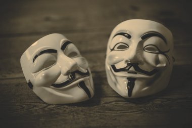 Anonymous mask  on wood background