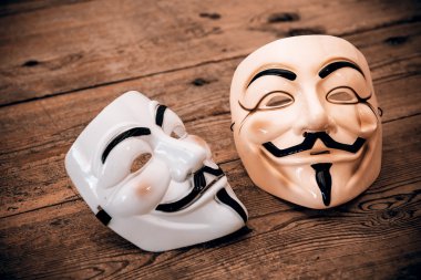 Anonymous mask on wood background
