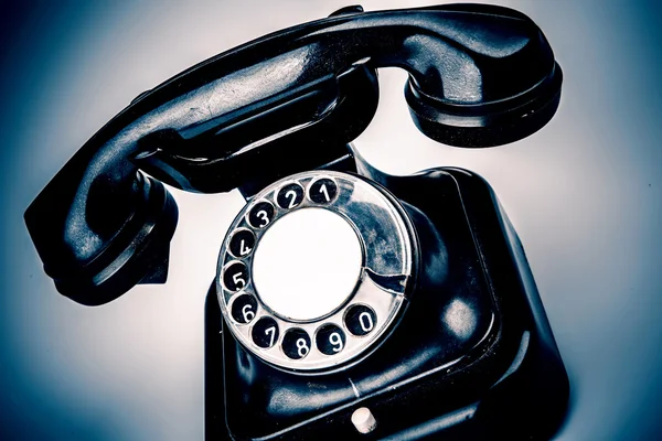 Old black phone with dust and scratches on white background — Stock Photo, Image