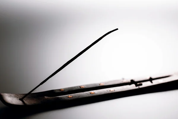 Incense stick on a wooden support on a white background — Stock Photo, Image