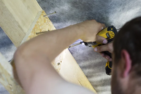 Black and yellow cordless drill in man hand Stock Image