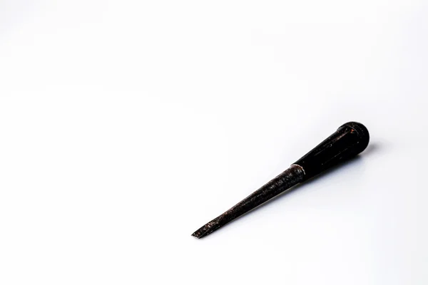 Old black screwdriver on white background — Stock Photo, Image